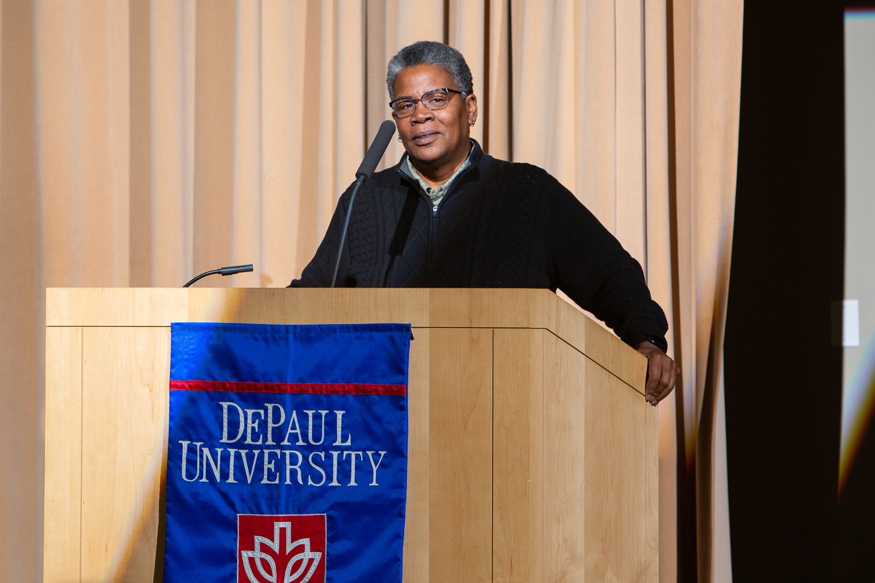 Carolyn Ross, CEO of All Chicago, offers remarks about the issue of housing insecurity in the city of Chicago. (DePaul University/Randall Spriggs)